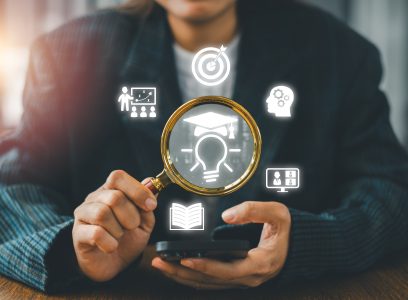 Businesswoman using magnifying glass to explore digital icons symbolizing innovation, education, and business strategy.