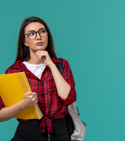 front-view-female-student-wearing-backpack-holding-files-thinking-light-blue-wall